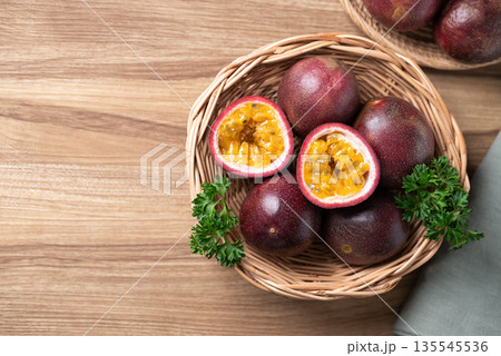 Fresh passion fruit in basket on wooden background, Tropical fruit, Table top view Fresh passion fruit in basket on wooden background, Tropical fruit, Table top view 135545536