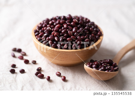 Azuki beans, Adzuki bean or red mung beans in wooden bowl and spoon on white fabric background 135545538