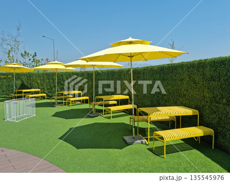 It is an outdoor cafe with parasols. 135545976