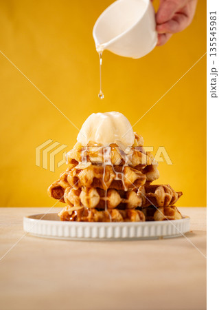 Stack of Belgian Waffles with Ice Cream and Syrup 135545981