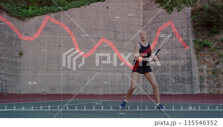Standing tennis player holding racket on red court, wall with grid graph overlay, copy space 135546352