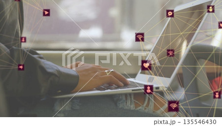 Typing Asian woman wearing ripped jeans, silver ring at moving train window, with laptop and icons Typing Asian woman wearing ripped jeans, silver ring at moving train window, with laptop and icons 135546430