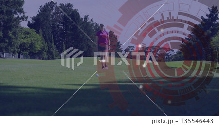 Walking female golfer wearing purple polo with glove toward golf ball on fairway, with HUD overlay 135546443