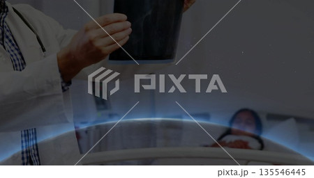 Holding chest X-ray film with stethoscope, doctor examining child patient in hospital, copy space 135546445