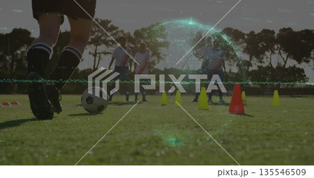 Player dribbling soccer ball on pitch at dusk, with cones, shin guards and cleats, copy space Player dribbling soccer ball on pitch at dusk, with cones, shin guards and cleats, copy space 135546509