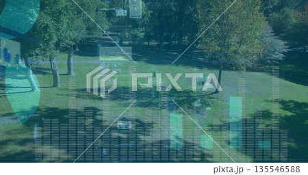 Projecting translucent bar charts line graphs and globe icons over park lawn, with wooden benches Projecting translucent bar charts line graphs and globe icons over park lawn, with wooden benches 135546588