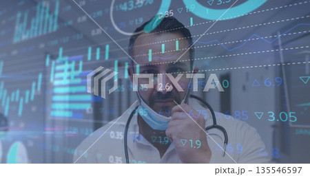 Lowering doctor pulling surgical mask from face in hospital corridor, with stethoscope, data charts Lowering doctor pulling surgical mask from face in hospital corridor, with stethoscope, data charts 135546597