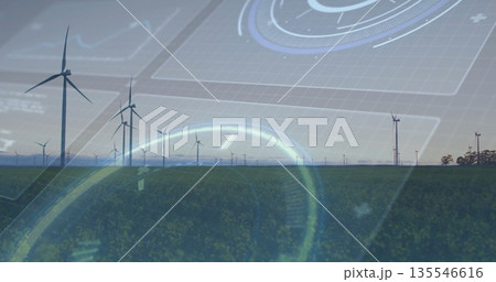 Displaying central cluster of wind turbines projecting data overlay over farmland, with digital HUD 135546616