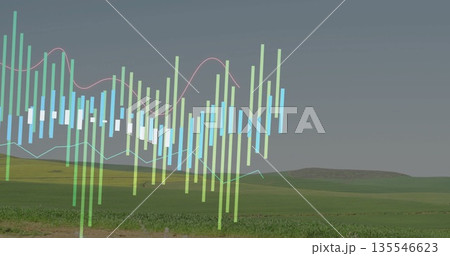 Floating translucent financial chart over rural hills and line graphs, with colorful candlesticks 135546623