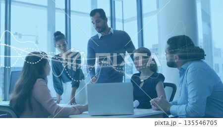 Collaborating five professionals analyzing dotted-line charts in modern meeting room, with laptop 135546705