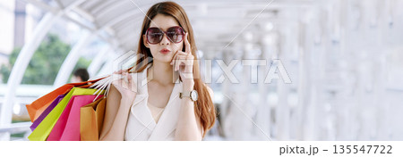 Banner Shopping bags of women crazy shopaholic person at fashion mall. Web Banner Woman love online shopping website holding shopping bags in hands with copy space. digital marketing happy lifestyle 135547722