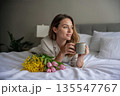 Serene Morning Routine with Fresh Flowers and Coffee in a Bright Bedroom 135547767