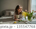 Serene Morning Routine with Fresh Flowers and Coffee in a Bright Bedroom 135547768