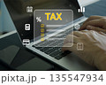 Hands typing on laptop with virtual tax checklist and finance icons, representing online tax filing, 135547934