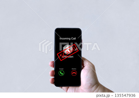 Smartphone screen shows unknown scam call, highlighting phone fraud risks, cyber threats Smartphone screen shows unknown scam call, highlighting phone fraud risks, cyber threats 135547936