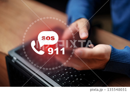 Urgent call for help made from a laptop in a home setting during daytime 135548031