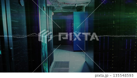 Glowing server cabinets lining narrow data center corridor, with LED indicators and cable trays 135548593