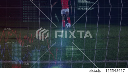 Soccer player in red jersey kicking ball behind goal net on grass turf, with data overlays Soccer player in red jersey kicking ball behind goal net on grass turf, with data overlays 135548637