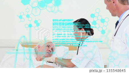 Leaning nurse placing stethoscope on senior patient chest on hospital bed, with digital overlay 135548645