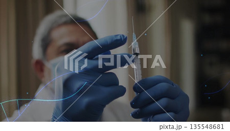 Drawing fluid into syringe by medical worker in clinic room, with white coat, mask, hairnet, gloves Drawing fluid into syringe by medical worker in clinic room, with white coat, mask, hairnet, gloves 135548681