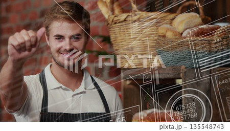Baker wearing apron giving thumbs up in bakery, with wicker baskets and digital overlays 135548743