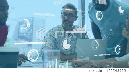 Reviewing data mature male with glasses typing on laptop at meeting desk, with documents and charts Reviewing data mature male with glasses typing on laptop at meeting desk, with documents and charts 135548936