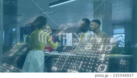 Presenting woman in chartreuse top gesturing to colleagues around office table, binary code overlay 135548937