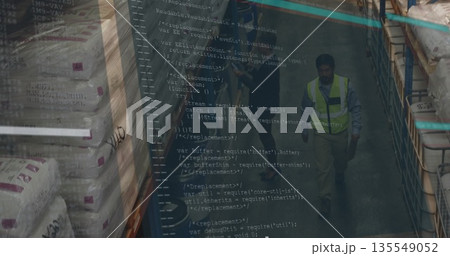 Walking worker in safety vest passing sacks on racks in warehouse aisle, code overlay, copy space Walking worker in safety vest passing sacks on racks in warehouse aisle, code overlay, copy space 135549052