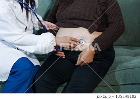 cropped shot of doctor examining pregnant woman during medical consultation cropped shot of doctor examining pregnant woman during medical consultation 135549182