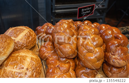 Braided Challah-Hallah Bread on a Rack Baked for the Sabbath and Ready to be Sold at the Bakery 135549222