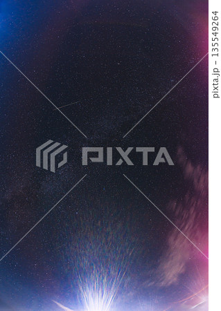 Aurora Borealis Over Starry Night Sky with Meteor and Radiant Light Burst 135549264