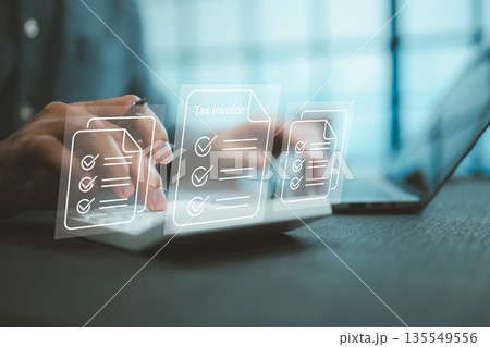 Person Using Calculator and Laptop with Tax Invoice Documents Concept Person Using Calculator and Laptop with Tax Invoice Documents Concept 135549556