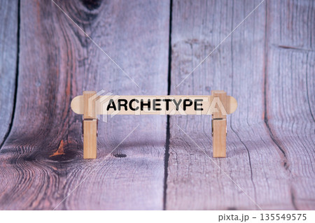 Archetype symbol. Single Wooden stick supported by Clothespins, beautiful Light Orange tone highlight Wooden Texture Background. Business and Archetype concept with copy space 135549575
