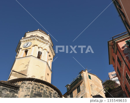 View of Vernazza, a town in Cinque Terre. Traditional buildings of Liguria, Italy. Architecture protected by UNESCO. Church of Santa Margherita. 135549633