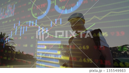 Standing Chinese golfer carrying golf bag with clubs on fairway, financial charts, copy space 135549983