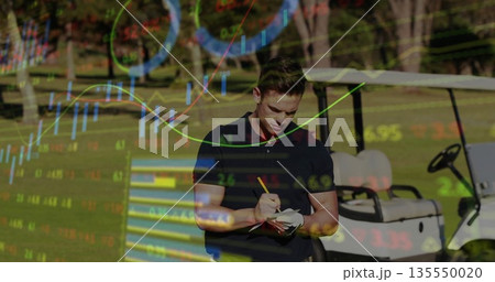 Golfer in polo shirt writing scorecard with pencil on fairway, with golf cart, stock market charts 135550020