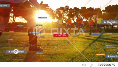 Taking shot seven women soccer players practicing on sunset field, with net, ball and UI overlays 135550075