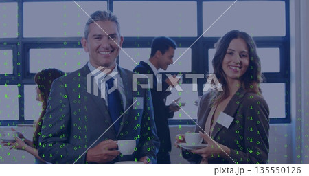 Smiling businessman and colleague holding coffee cups in conference break area, with coffee carafe Smiling businessman and colleague holding coffee cups in conference break area, with coffee carafe 135550126