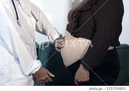 cropped shot of doctor examining pregnant woman during medical consultation cropped shot of doctor examining pregnant woman during medical consultation 135550801