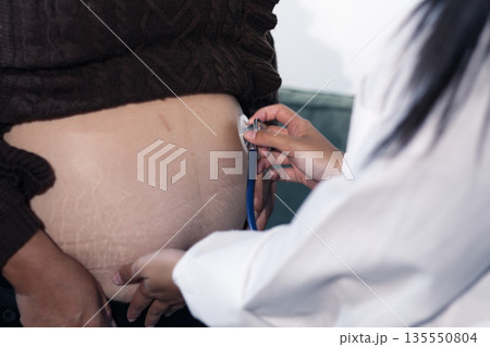 cropped shot of doctor examining pregnant woman during medical consultation cropped shot of doctor examining pregnant woman during medical consultation 135550804