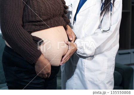 cropped shot of doctor examining pregnant woman during medical consultation cropped shot of doctor examining pregnant woman during medical consultation 135550808