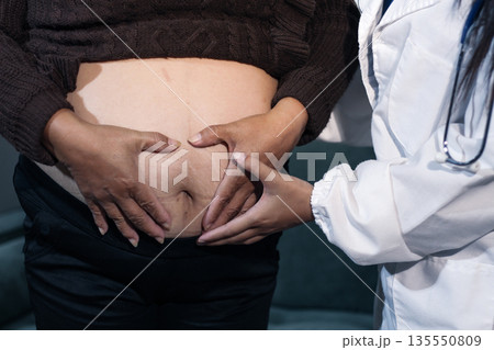 cropped shot of doctor examining pregnant woman during medical consultation cropped shot of doctor examining pregnant woman during medical consultation 135550809