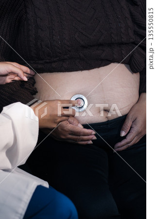 cropped shot of doctor examining pregnant woman during medical consultation cropped shot of doctor examining pregnant woman during medical consultation 135550815