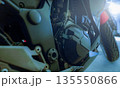 Motorcycle engine and mechanical components on modern road bike. Engineering precision, metal structure, and performance design for transportation, maintenance, and automotive technology concept. 135550866