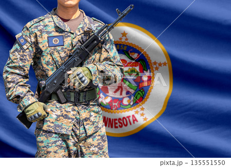 Minnesota US state flag with soldier holding assault rifle 135551550