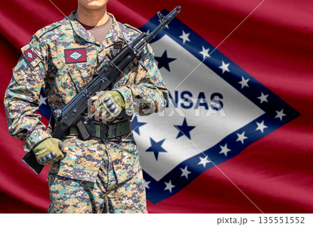 Arkansas US state flag with soldier holding assault rifle 135551552