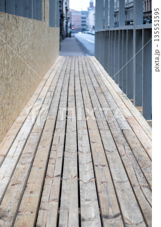 Wooden Construction Walkway Along Urban Street With Plank Flooring 135551595