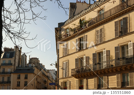 Parisian Haussmann architecture with balconies and open shutters on an urban street. Paris, France Parisian Haussmann architecture with balconies and open shutters on an urban street. Paris, France 135551860