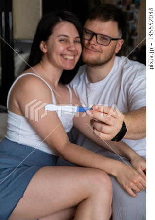 Happy Couple Celebrating Positive Pregnancy Test 135552038