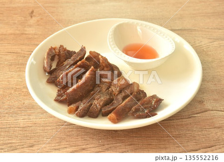fried crispy salty fermenting beef fat meat with pepper on plate dipping spicy and sour chili sauce 135552216